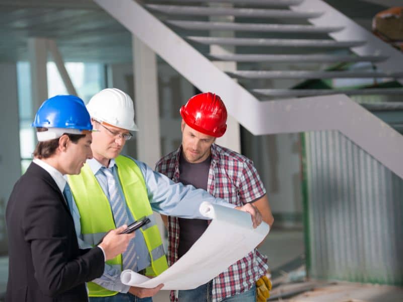 Design professionals reviewing plans supported by topographic survey information during project development