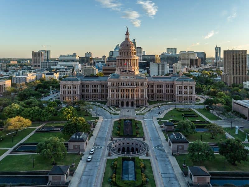 Texas State Capitol and downtown Austin skyline representing professional land surveying services, property surveys, and land development planning in Austin, Texas